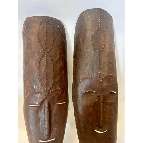 484 - Two Tribal Metal Decorative Masks. 52cm x 17cm.   (2)