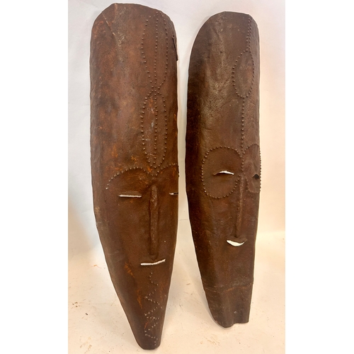 484 - Two Tribal Metal Decorative Masks. 52cm x 17cm.   (2)