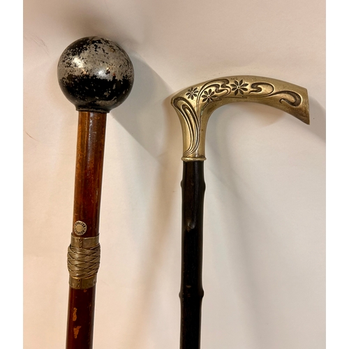 509 - Two Interesting Walking Sticks, One With Heavy Ball Finial And The Other Decorative Silver Coloured ... 