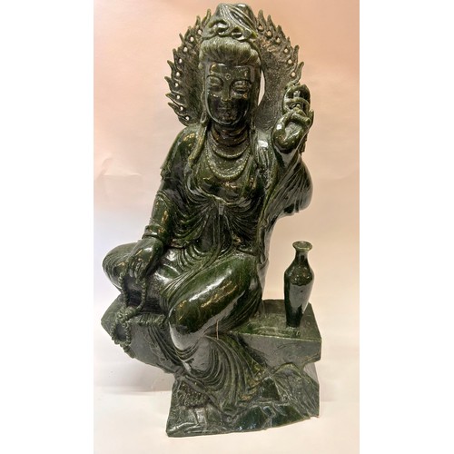 589 - A Large Chinese Dark Green Jade Seated Figure Of Guanyin Holding A Umbrella And Beads. 53 x 31 x 22 ... 