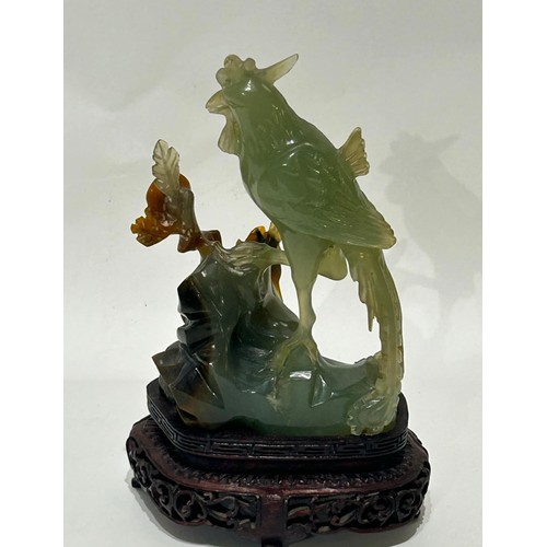 32 - Oriental jade figure of a bird and flower mounted on a carved wooden base. Measures 19cm high x 12cm