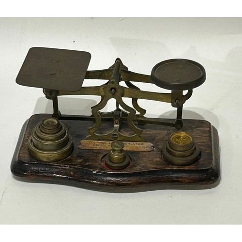 41 - Vintage Brass postal scales to include brass weights on wooden base. 10 weights in total.  Measures ... 