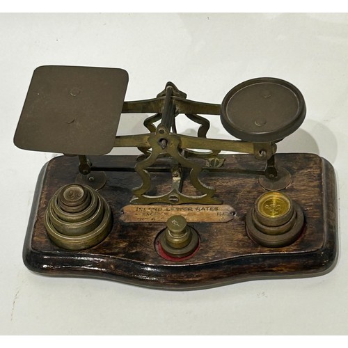 41 - Vintage Brass postal scales to include brass weights on wooden base. 10 weights in total.  Measures ... 