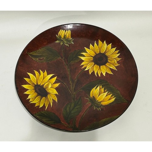 37 - Studio pottery wall plate depicting sunflowers. Mark to base. Measures 31.5cm diam