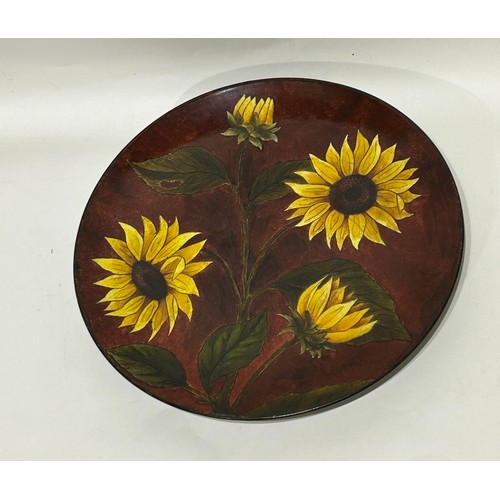 37 - Studio pottery wall plate depicting sunflowers. Mark to base. Measures 31.5cm diam