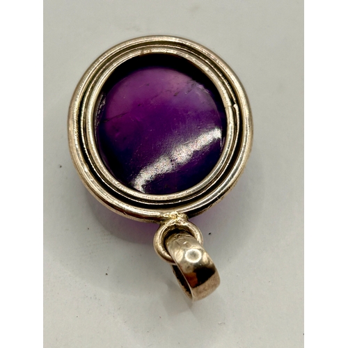 233 - Stamped 925 Silver Pendant With Large Central Purple Amethyst Stone. 4cm x 2.5cm.