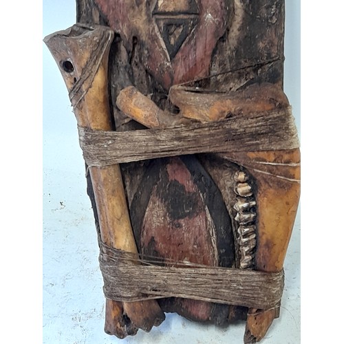 422 - Tribal Artefact consisting of a Carved face on wood plank with Bound Bones, 43cm x 15cm