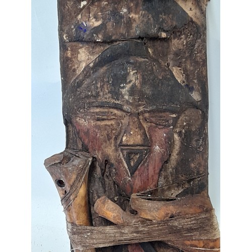 422 - Tribal Artefact consisting of a Carved face on wood plank with Bound Bones, 43cm x 15cm