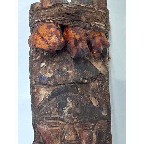 422 - Tribal Artefact consisting of a Carved face on wood plank with Bound Bones, 43cm x 15cm