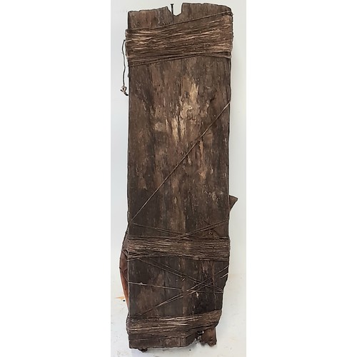 422 - Tribal Artefact consisting of a Carved face on wood plank with Bound Bones, 43cm x 15cm