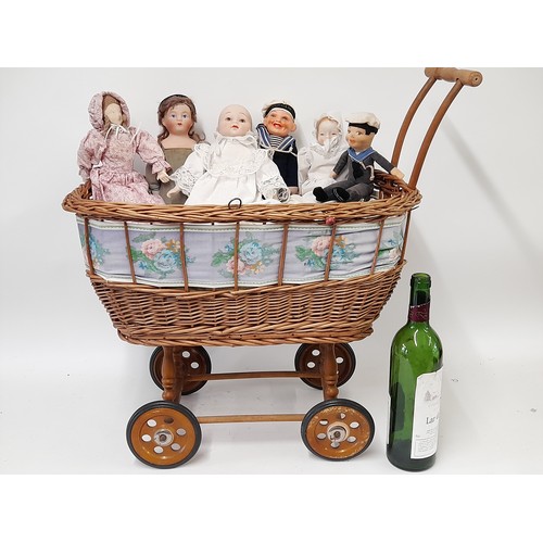 475 - Vintage Childs Cane Pram with 6 small dolls, Pram 52cm x 32cm x 57cm