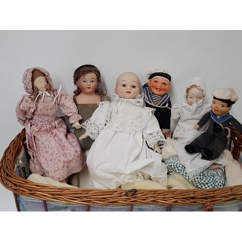 475 - Vintage Childs Cane Pram with 6 small dolls, Pram 52cm x 32cm x 57cm