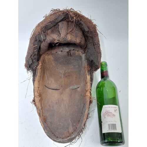 181 - Tribal Mask, Large Carved wood Face Mask with hood to rear, decorated with feathers and white markin... 