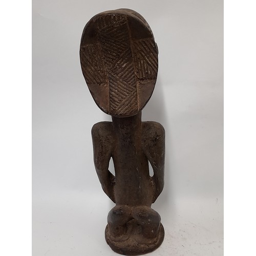 193 - Tribal Figure, Heavy Carved Wood Figure with carved decoration to head, 49cm high