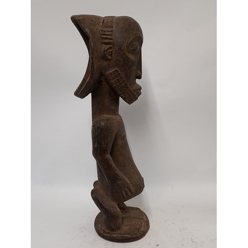 193 - Tribal Figure, Heavy Carved Wood Figure with carved decoration to head, 49cm high