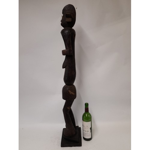 194 - Tribal Figure, Very Tall carved wood figure on plinth standing 102cm high