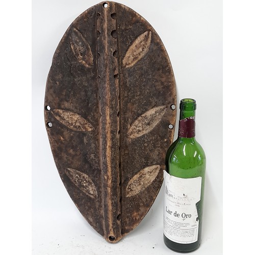 201 - Tribal Carved wood Oval Shield with carved leaf decoration, 48cm x 27cm