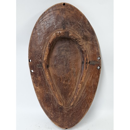 201 - Tribal Carved wood Oval Shield with carved leaf decoration, 48cm x 27cm