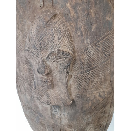 204 - Tribal Carved wood Shield with face and geometric carved design, 90cm x 40cm