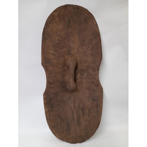 204 - Tribal Carved wood Shield with face and geometric carved design, 90cm x 40cm