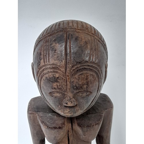 206 - Tribal Figure, Carved wood figure with carved decoration to head, 38cm high