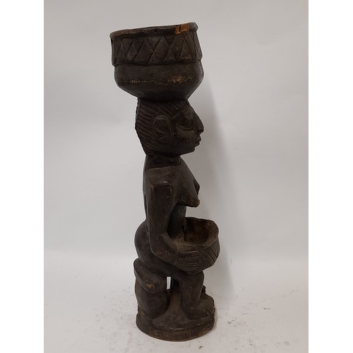 210 - Tribal Figure, Carved wood figure of a woman carrying a basket on her head, 49cm high