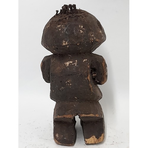 213 - Tribal Figure, Carved wood Fetish figure with nail hammered into head, 24cm high