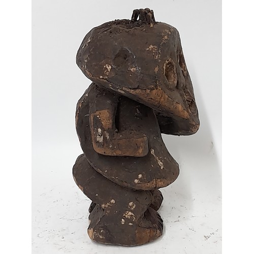 213 - Tribal Figure, Carved wood Fetish figure with nail hammered into head, 24cm high