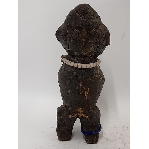 215 - Tribal Figure, Carved wood Figure with beads around neck and ankle, 26cm high