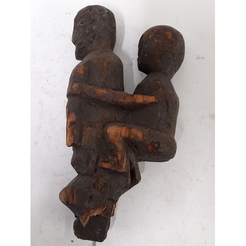 221 - Carved wood Tribal figure of parent carrying a child, 32cm high