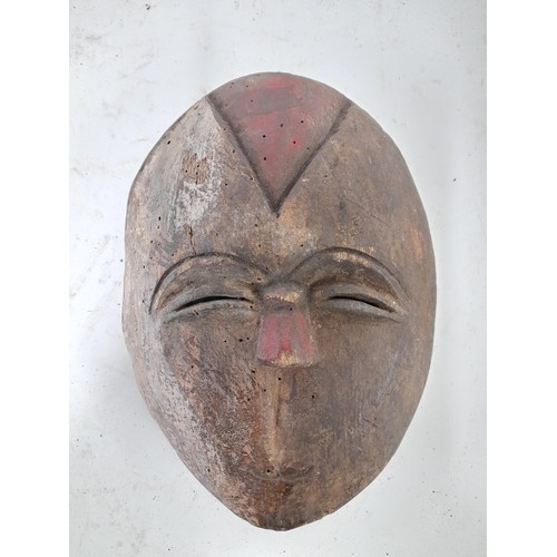 225 - Tribal Figure, small Carved wood Face Mask with remains of red and white colour, 18cm x 14cm