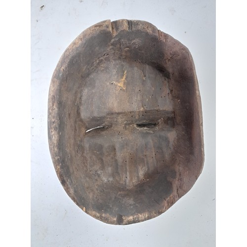 225 - Tribal Figure, small Carved wood Face Mask with remains of red and white colour, 18cm x 14cm