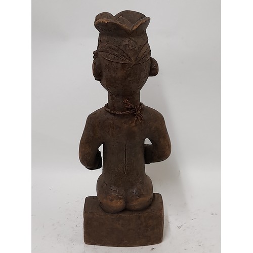 236 - Tribal Figure, Seated Tribesman with head dress, 40cm high