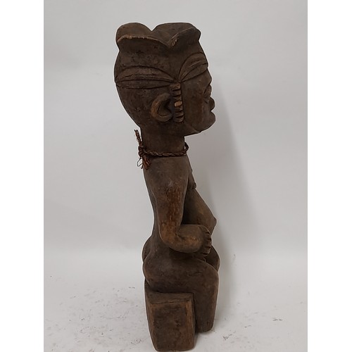 236 - Tribal Figure, Seated Tribesman with head dress, 40cm high