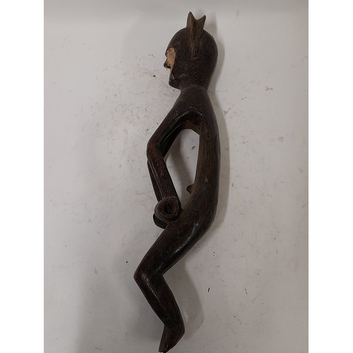 239 - Tribal Figure, Figure with white face in crouching pose, 51cm long