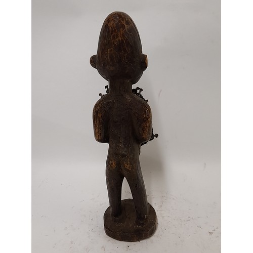 240 - Tribal Figure, Fetish Figure of a white faced figure with nails hammered into chest, 35cm high