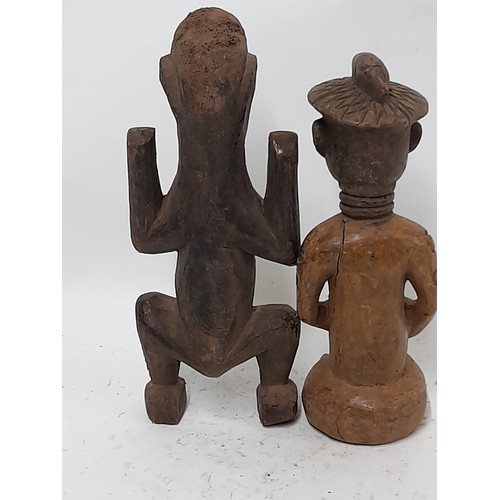 255 - 2 x Carved wood tribal figures, one with white face, 27cm high