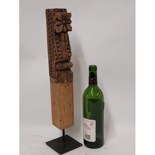 83 - Carved wood possibly a Temple carving mounted to wooden block and metal stand, 50cm high