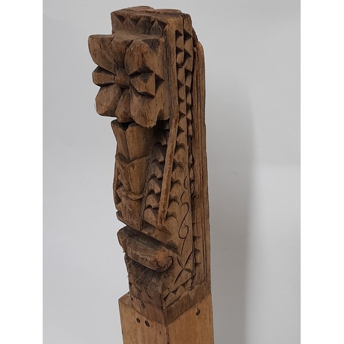 83 - Carved wood possibly a Temple carving mounted to wooden block and metal stand, 50cm high