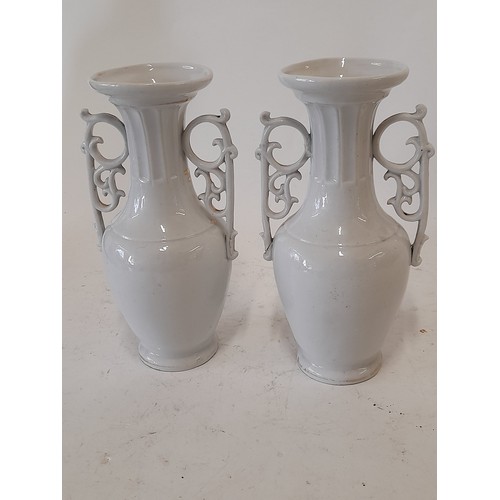 346 - Pair of Continental Porcelain Urns with Relief Moulded design, 18cm high