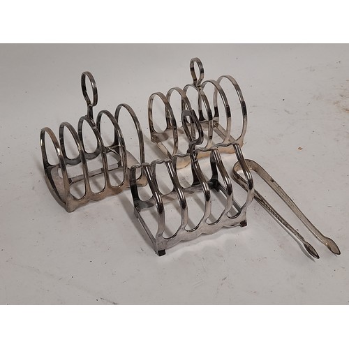 554 - 3 x Four slice EPNS Toast Racks and  a pair of Sugar Tongs