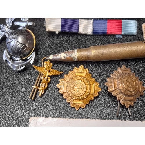 597 - Group of Military Related Items to include Ribbons, Insignia etc.      (13)