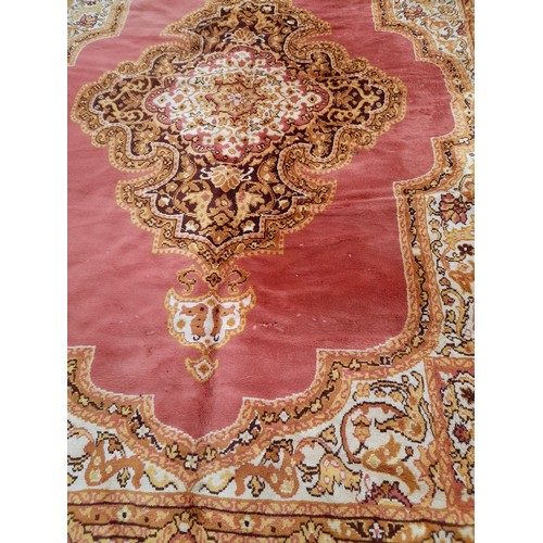 649 - Large Gold and Salmon Pink Rug with Central design, some damage, 328cm x 252cm