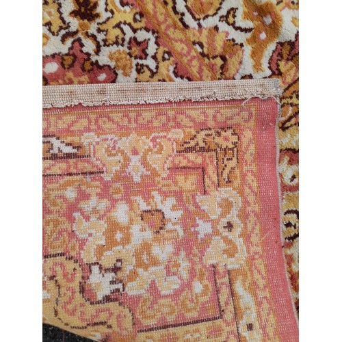 649 - Large Gold and Salmon Pink Rug with Central design, some damage, 328cm x 252cm