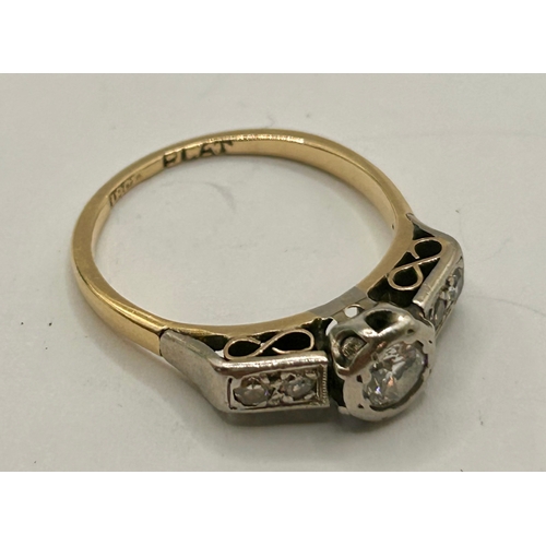 265 - 18Ct Gold And Platinum Ring With Central Diamond Along With Two Smaller Stones Flanking Either Side.... 