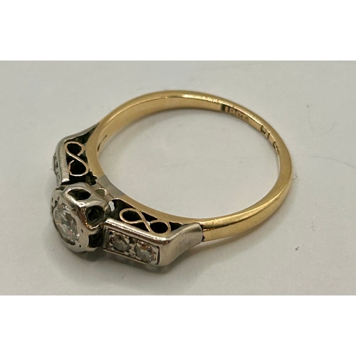 265 - 18Ct Gold And Platinum Ring With Central Diamond Along With Two Smaller Stones Flanking Either Side.... 