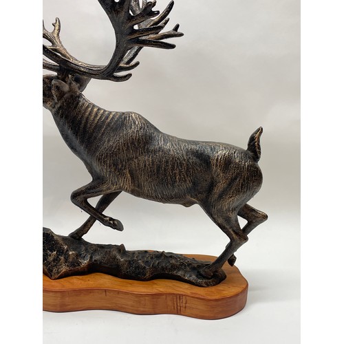 181 - Large Bronzed  Cast Iron Figure Of A Stag Mounted On Wood Plinth. 43 cms High x 38 cms