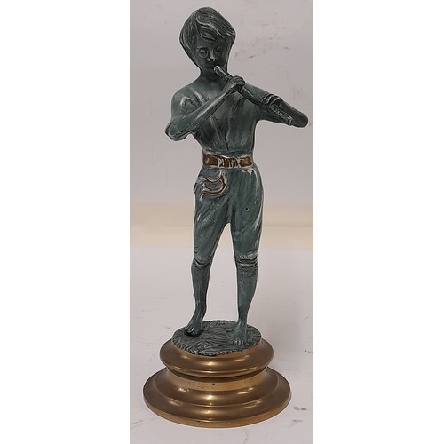 184 - Brass Figure with a Patinated Finish of a boy playing a Wind instrument, 25cm tall
