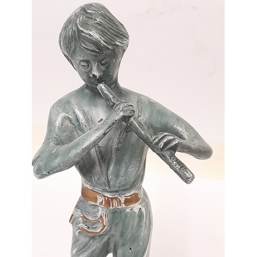 184 - Brass Figure with a Patinated Finish of a boy playing a Wind instrument, 25cm tall