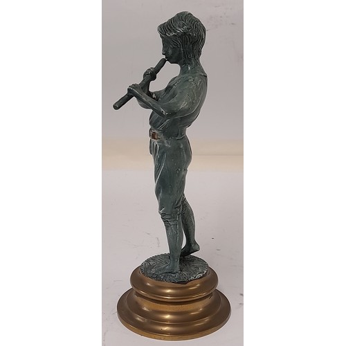 184 - Brass Figure with a Patinated Finish of a boy playing a Wind instrument, 25cm tall